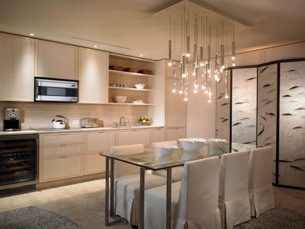 A stylish kitchen with a dining table and chairs, designed with haute couture interior design.