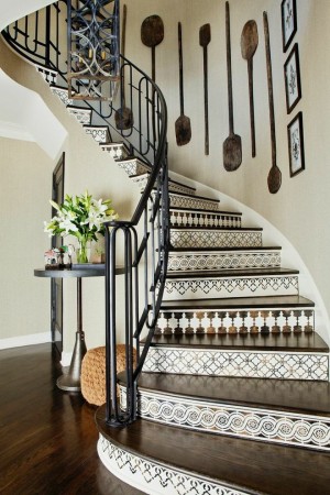 A creatively designed staircase with a black and white tiled floor.