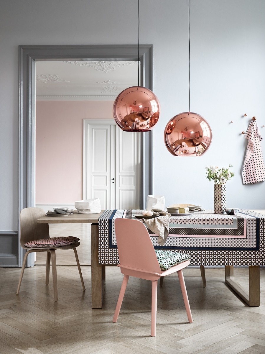 A dining room with rose gold table and chairs.
