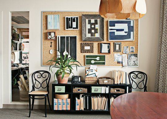 A unique gallery wall is accented with a cork board