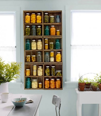 A kitchen with lots of jars on the wall repurposes wood crates.