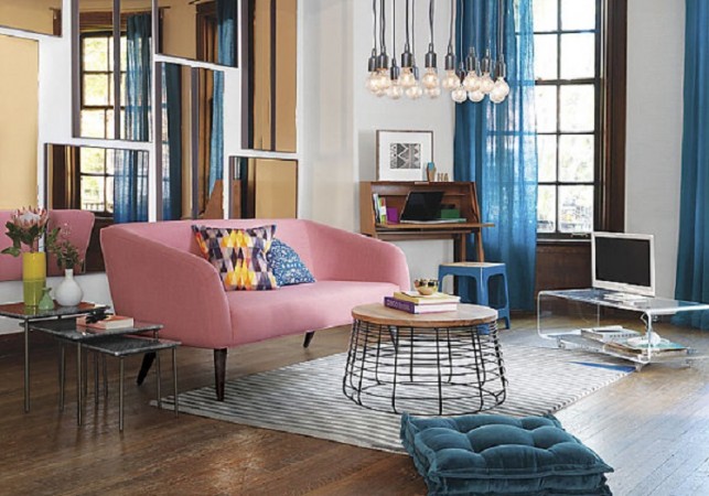 A living room with a pink couch and mirrors showcasing 2016's colors of the year.
