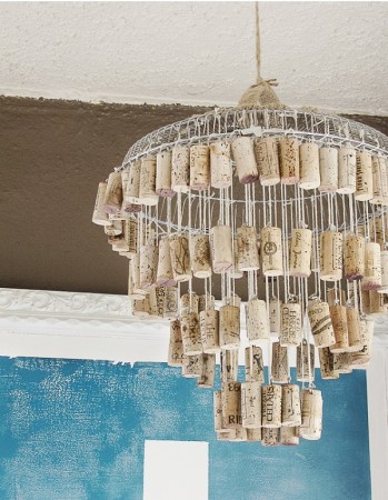 A repurposed chandelier made from wine corks hanging in a room.