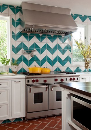 A tiled kitchen with a stove and oven featuring beautiful backsplash ideas.