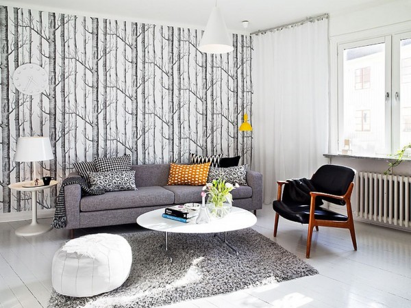 A warm and welcoming living room with winter-inspired interiors featuring grey and white furniture.