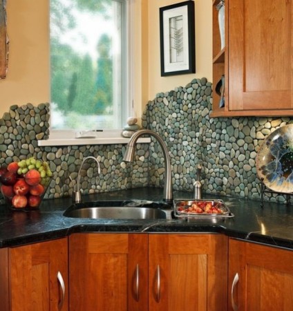 A kitchen with a beautiful stone backsplash.