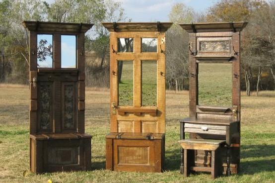 Three old wooden chairs and a mirror in a field showcasing great ideas for repurposed doors.