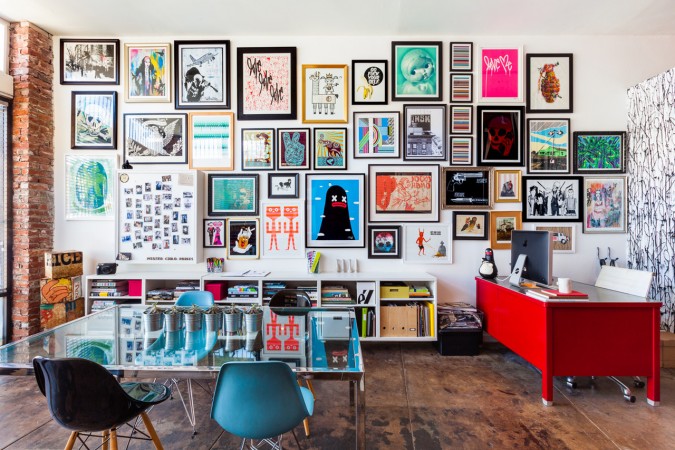 A variety of colors and art decorate this gallery wall