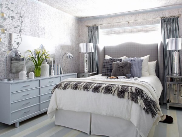 A warm and welcoming bedroom with a bed, dresser, and mirror, featuring winter-inspired interiors.