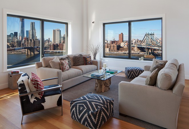 A living room with a view of the city in a beautiful city apartment.