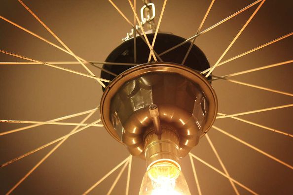 A Repurposed Light Fixture: A bicycle wheel hanging from a ceiling.