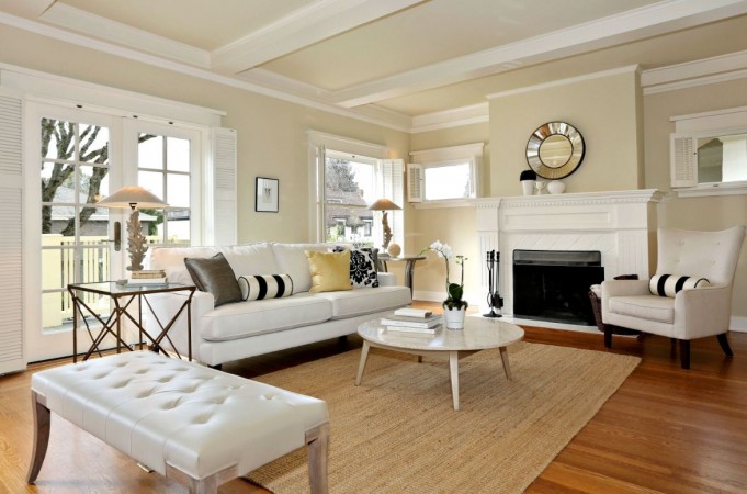A white living room with hardwood floors and a fireplace. Refreshing living room after the holidays.