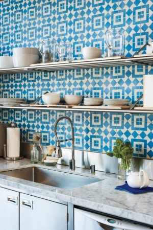 Beautiful blue and white tiled backsplash adding character to kitchen.