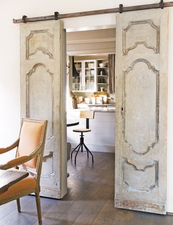 An old barn door in a dining room is one of the great ideas for repurposed doors.