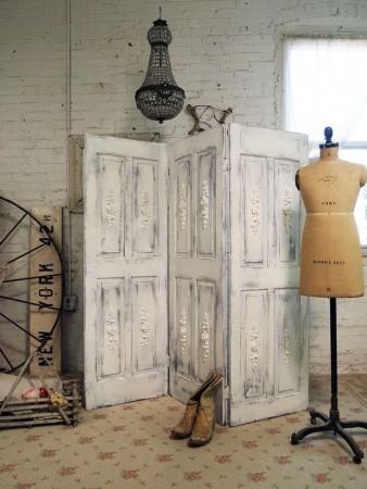 A mannequin room divider with repurposed doors.