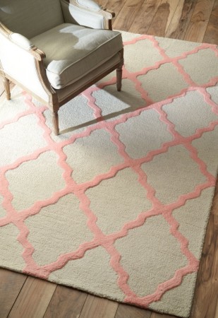A pink and white rug incorporating 2016's Colors of the Year, with a chair on the floor.