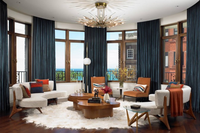 A living room with a large window overlooking the ocean, perfect for refreshing after the holidays.