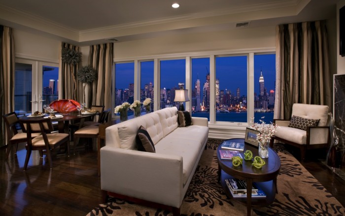 A living room with a view of the city in a beautiful city apartment.