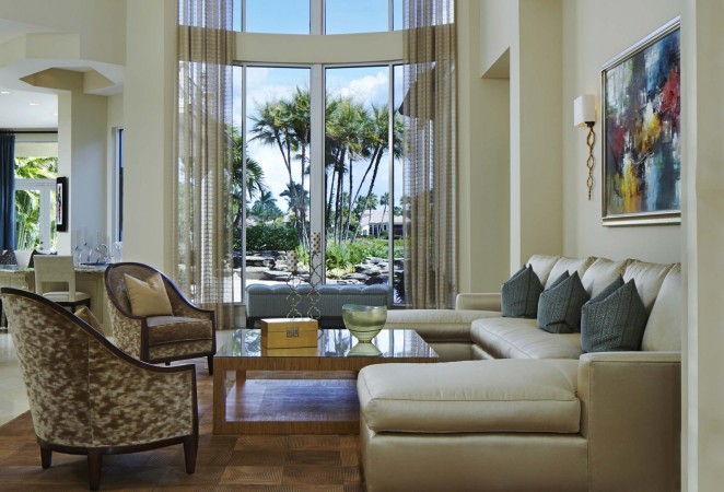 A bold and beautiful living room with a large window, inspired by Palm Beach style.