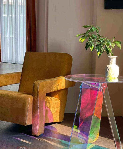 Cozy interior with rainbow prism table and potted plant.
