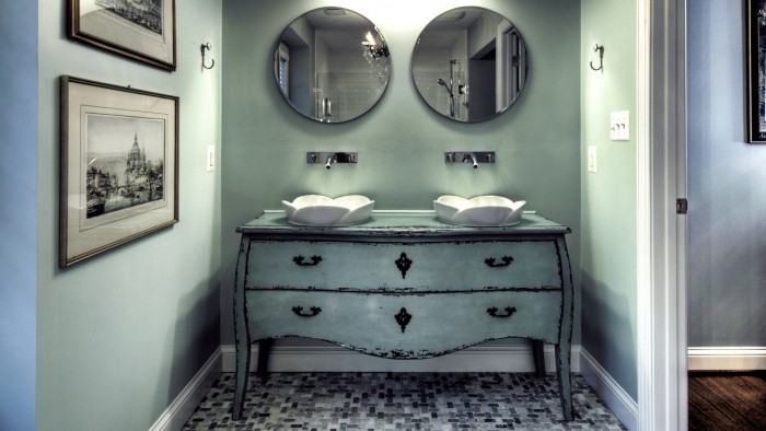 A dresser is repurposed as a unique bathroom vanity