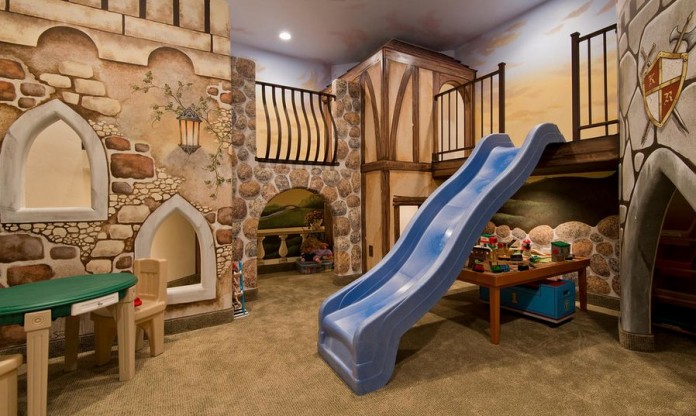 An elaborate tudor-village playroom with slide and lofts (homedit).