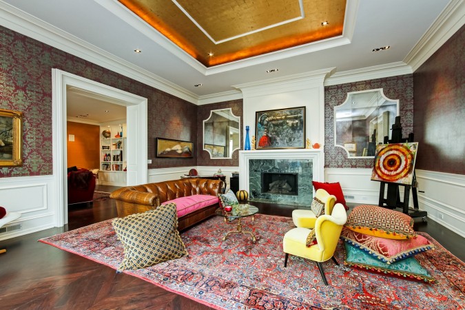 A living room with colorful furniture and a fireplace that is quirky and funky.