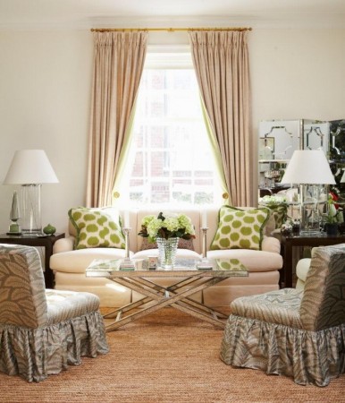 A living room with beige and green furniture featuring shimmer and luster.