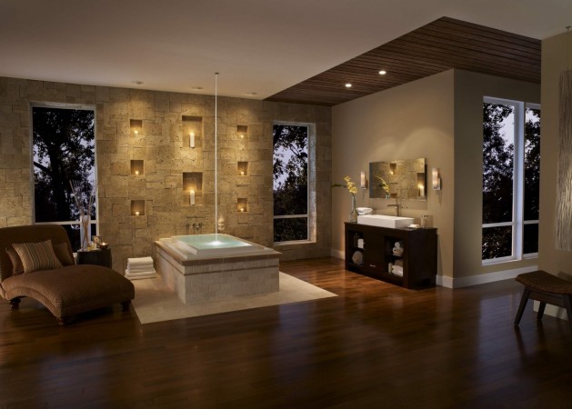 A luxurious bathroom with wooden floors and a bathtub.