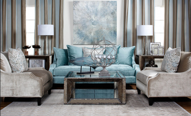 A living room with blue and beige furniture featuring shimmer and luster.