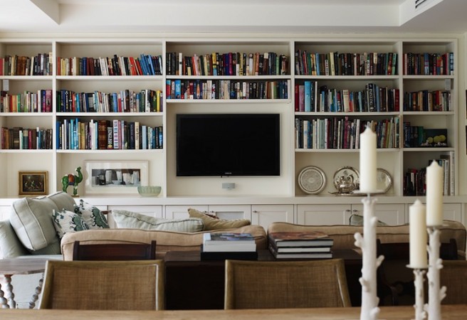 A living room with bookshelves as a feature wall.