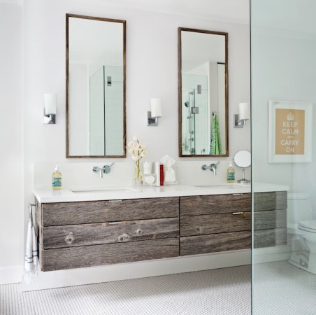 A bathroom with two unique sinks and a mirror to add character.