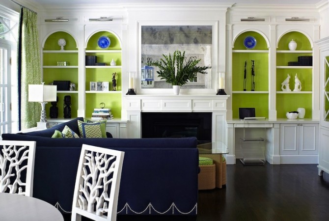 A living room with a lime green feature wall and blue furniture.