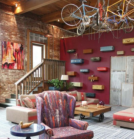 A living room with 20 quirky bicycles hanging from the ceiling.