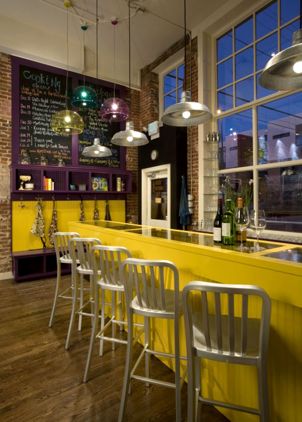 Keywords used: French, Bistro

Description: A brightly colored bistro bar with stools and a bottle of wine.