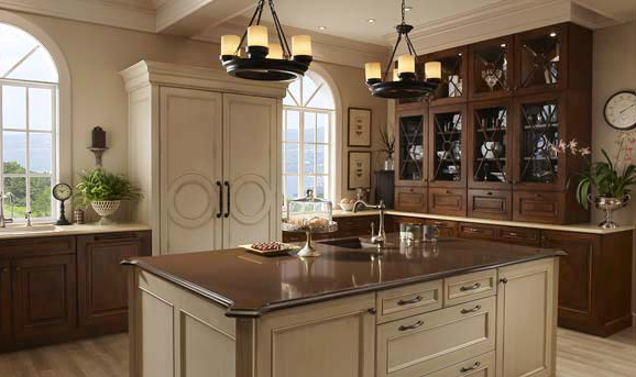 A kitchen with mixed cabinet finishes and a center island.