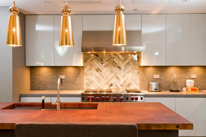 A modern kitchen with a wooden counter top featuring shimmer and luster.