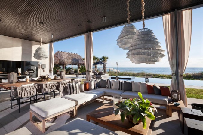 An luxurious outdoor living room with a breathtaking view of the ocean.