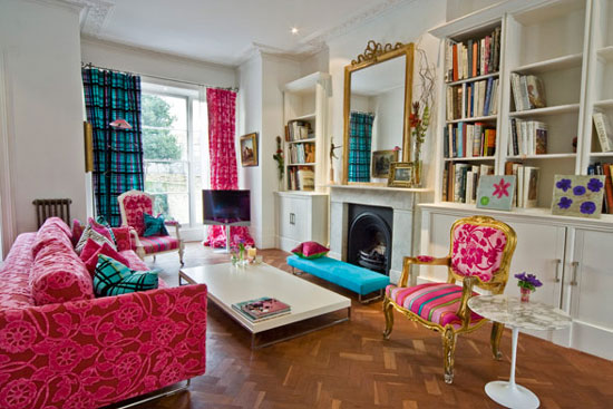A quirky living room with colorful furniture and bookshelves to love.