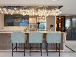 A shimmering display of lights reflect off metallic kitchen tiles