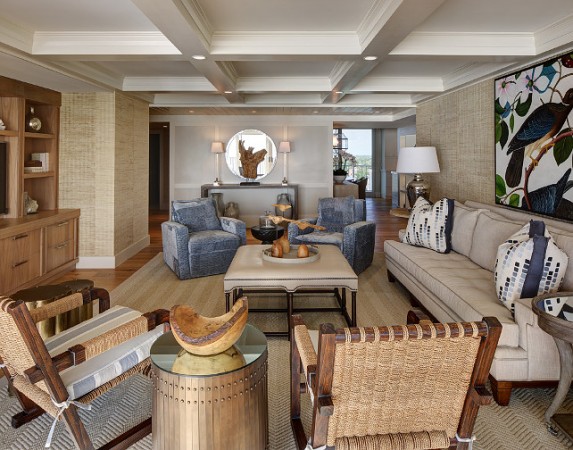 A living room with chic beach vibes featuring couches, chairs, and a coffee table.