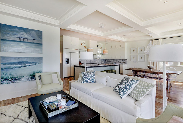 A living room with a white couch and a coffee table with a chic beach look.