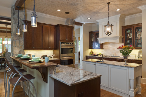 A large kitchen with a center island featuring mixed cabinet finishes.