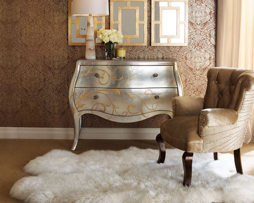 A room with a gold dresser and a chair adds shimmer and luster to your home.