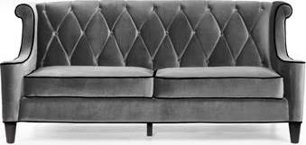 A black and white photo of a Gatsby-style velvet sofa.