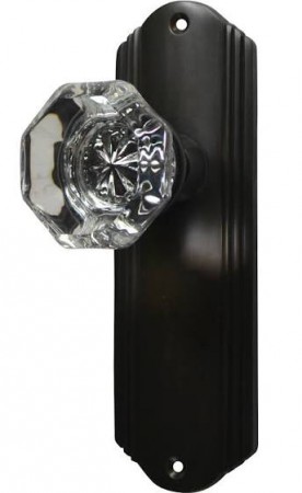 A black door handle with a Gatsby-style glass door knob from the 1920s.