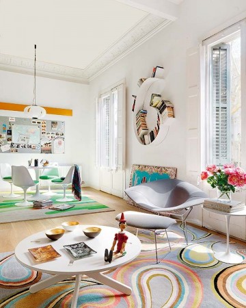 A funky living room with a colorful rug.