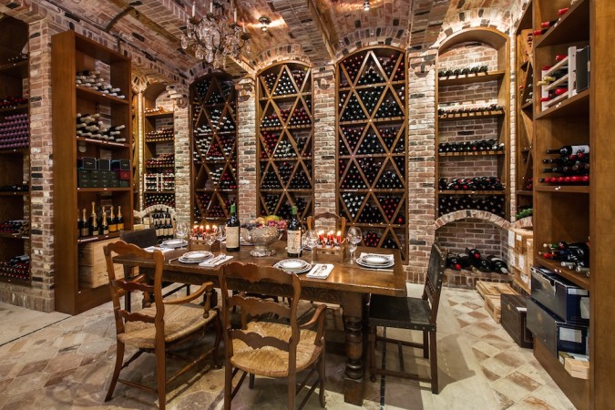 A luxurious wine cellar with a table and chairs, perfect for hosting elegant gatherings.