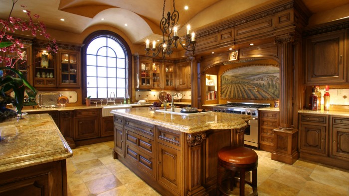 A large kitchen with wooden cabinets and a center island in luxury homes.