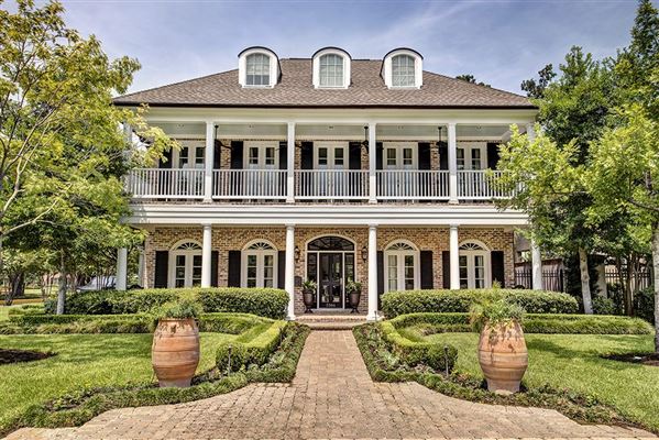 A luxurious home with a spacious front porch.